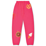 Bright pink kids’ holiday sweatpants with whimsical ornament graphics including a donut, pretzel, butterfly, and ice cream cone.