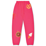 Bright pink kids’ holiday sweatpants with whimsical ornament graphics including a donut, pretzel, butterfly, and ice cream cone.