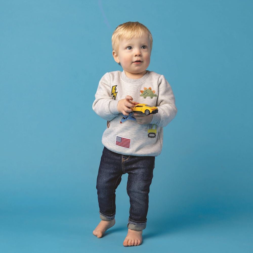 Gray toddler sweatshirt with felt and boucle patches of football, dinosaur, plane, and more