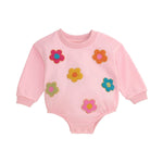 Pink baby sweatshirt bubble with colorful bouclé flower appliqués and snap leg closure