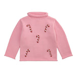 Pink sweater with candy cane patterns on a white background