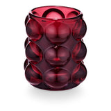 Pomme Rouge candle in red bubbled glass vessel with grape, clove, and ginger fragrance