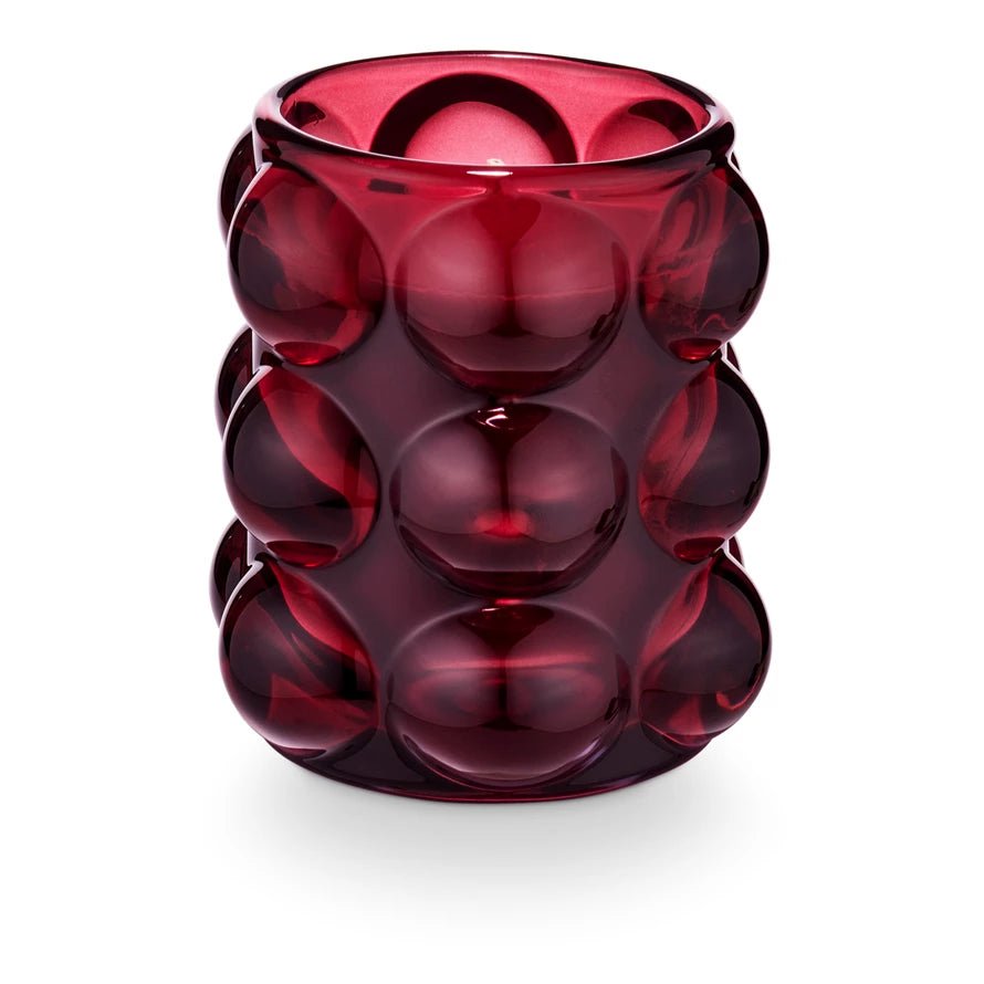 Pomme Rouge candle in red bubbled glass vessel with grape, clove, and ginger fragrance