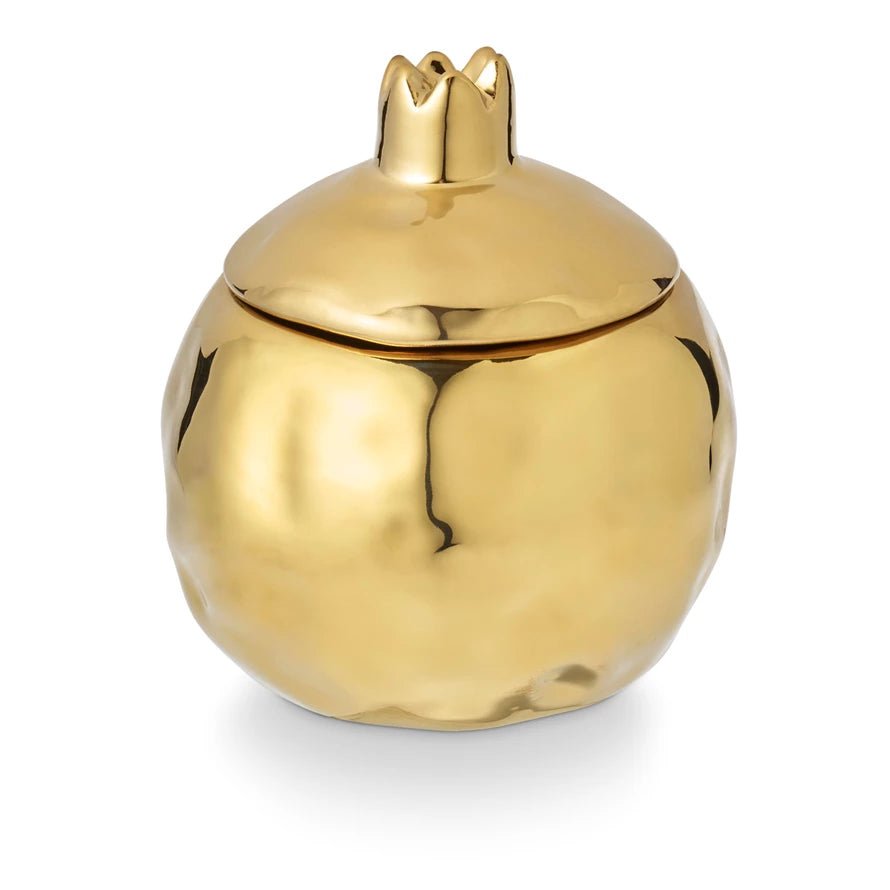 Pomme Rouge candle in shiny gold pomegranate-shaped jar with rich fruity-spice fragrance