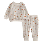 Children's outfit with sweatshirt and pants featuring pumpkin pattern on a white background