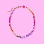 Colorful beaded necklace with magnetic clasp and gold extender, arranged in a rainbow gradient