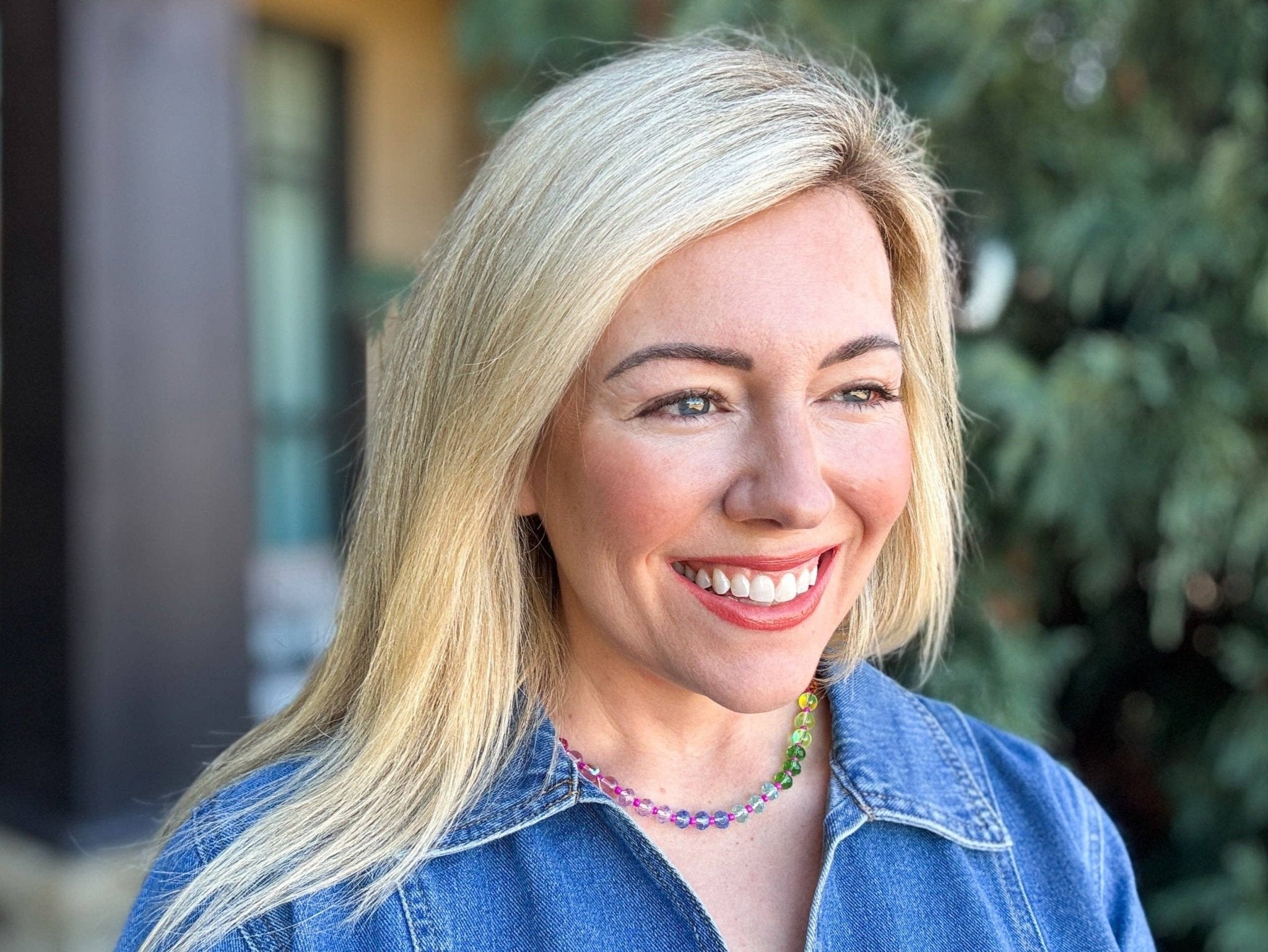 Colorful beaded necklace with magnetic clasp and gold extender, arranged in a rainbow gradient