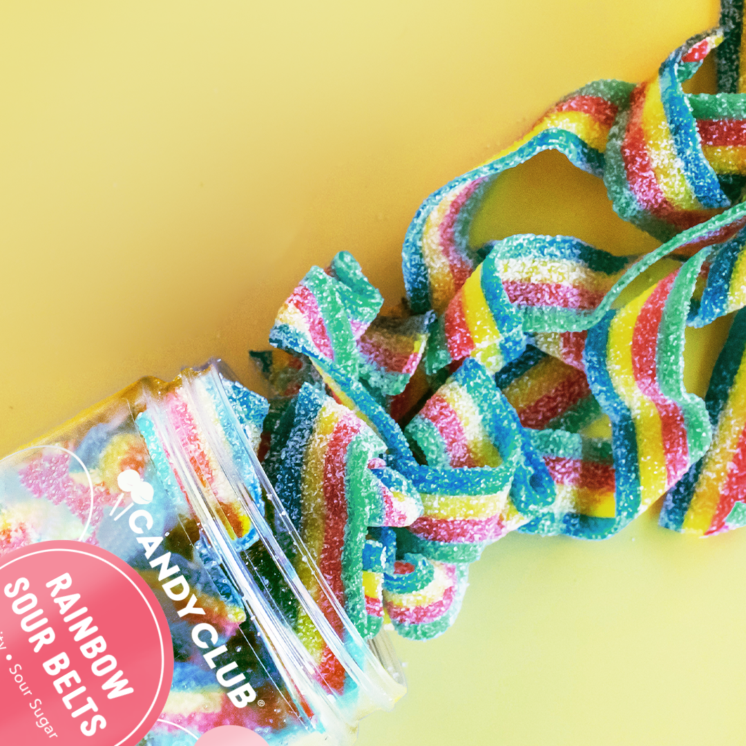 Colorful gummy belts from Candy Club on a yellow background
