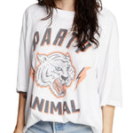 Woman wearing oversized "Party Animal" graphic tee featuring tiger and lightning bolt design