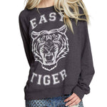 Model wearing oversized vintage-style “Easy Tiger” sweatshirt with fierce white tiger graphic