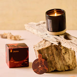 Crush candle in black ceramic vessel with packaging, styled for fall
