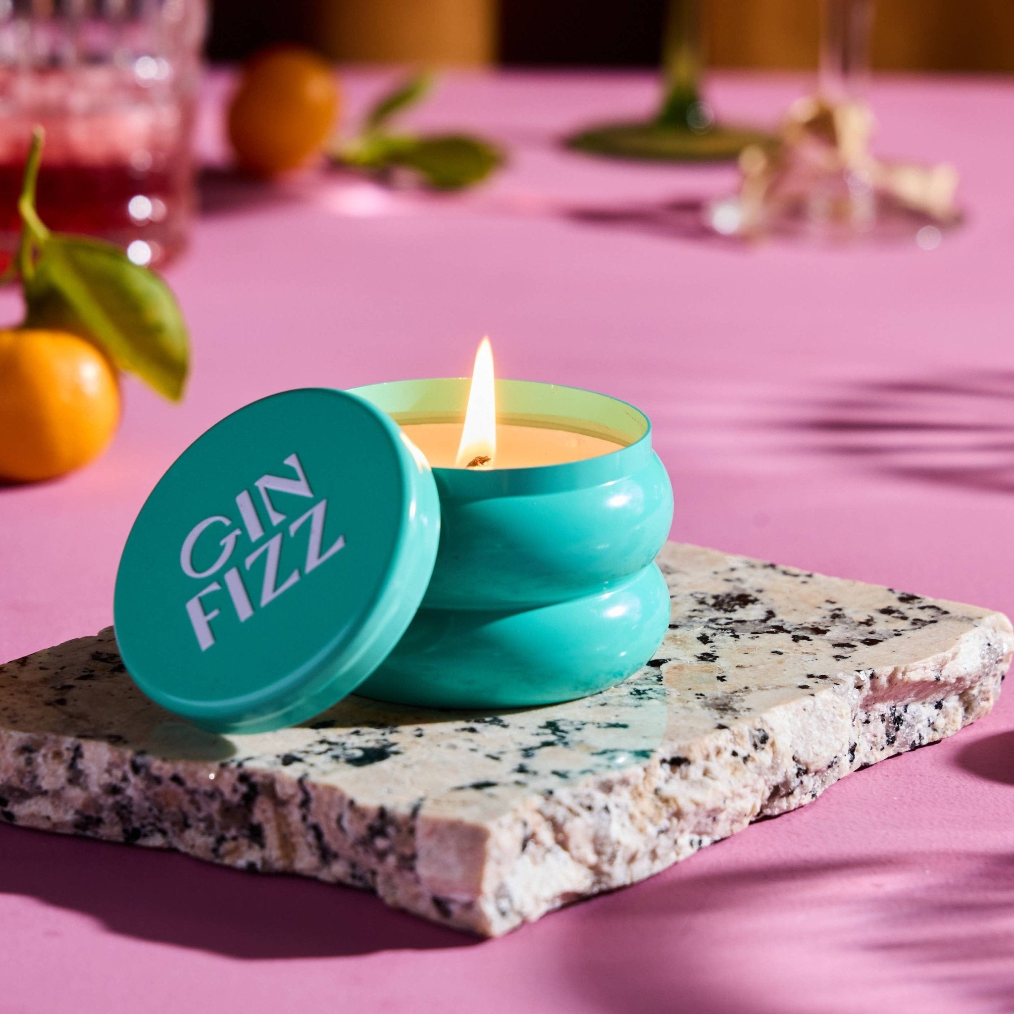 Gin Fizz candle in turquoise sculptural tin with flame