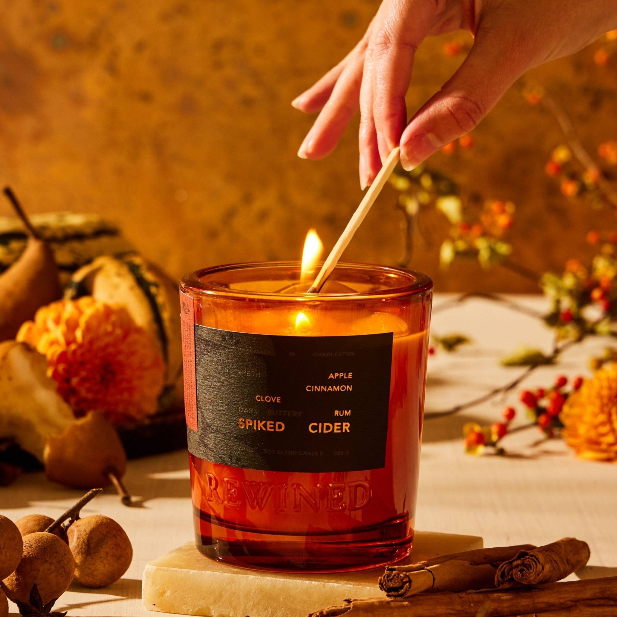 Spiked Cider candle in amber glass jar with black label