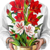 Woman holding a tall pop-up bouquet of red and white amaryllis flowers in a gold hammered bowl