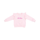 Ruffle shoulder Lil Sis sweatshirt with French terry fabric, playful ruffle accents, and applique text.