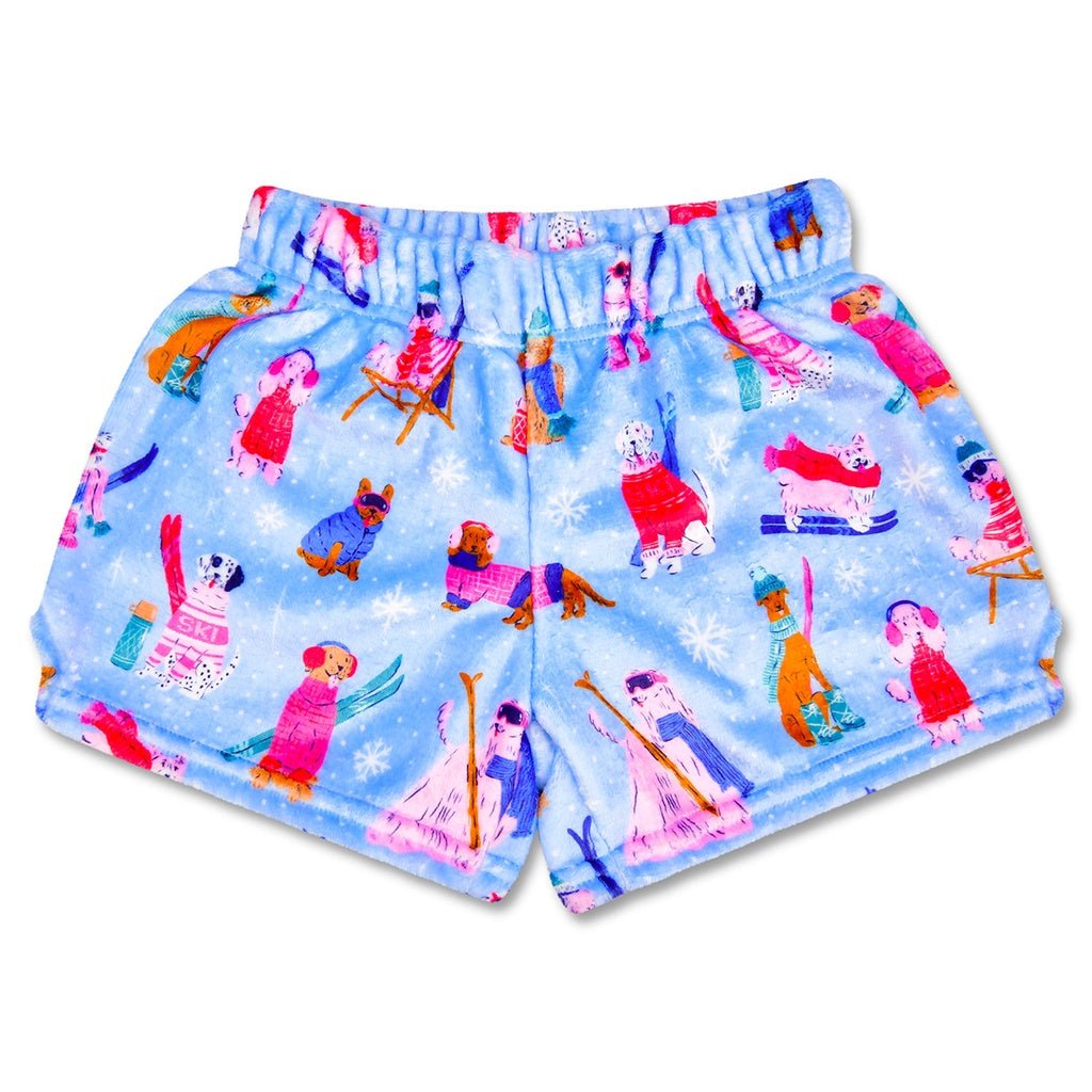 Children’s Ski Dogs plush shorts with blue snowy background and playful dogs skiing, snowboarding, and wearing winter sweaters.