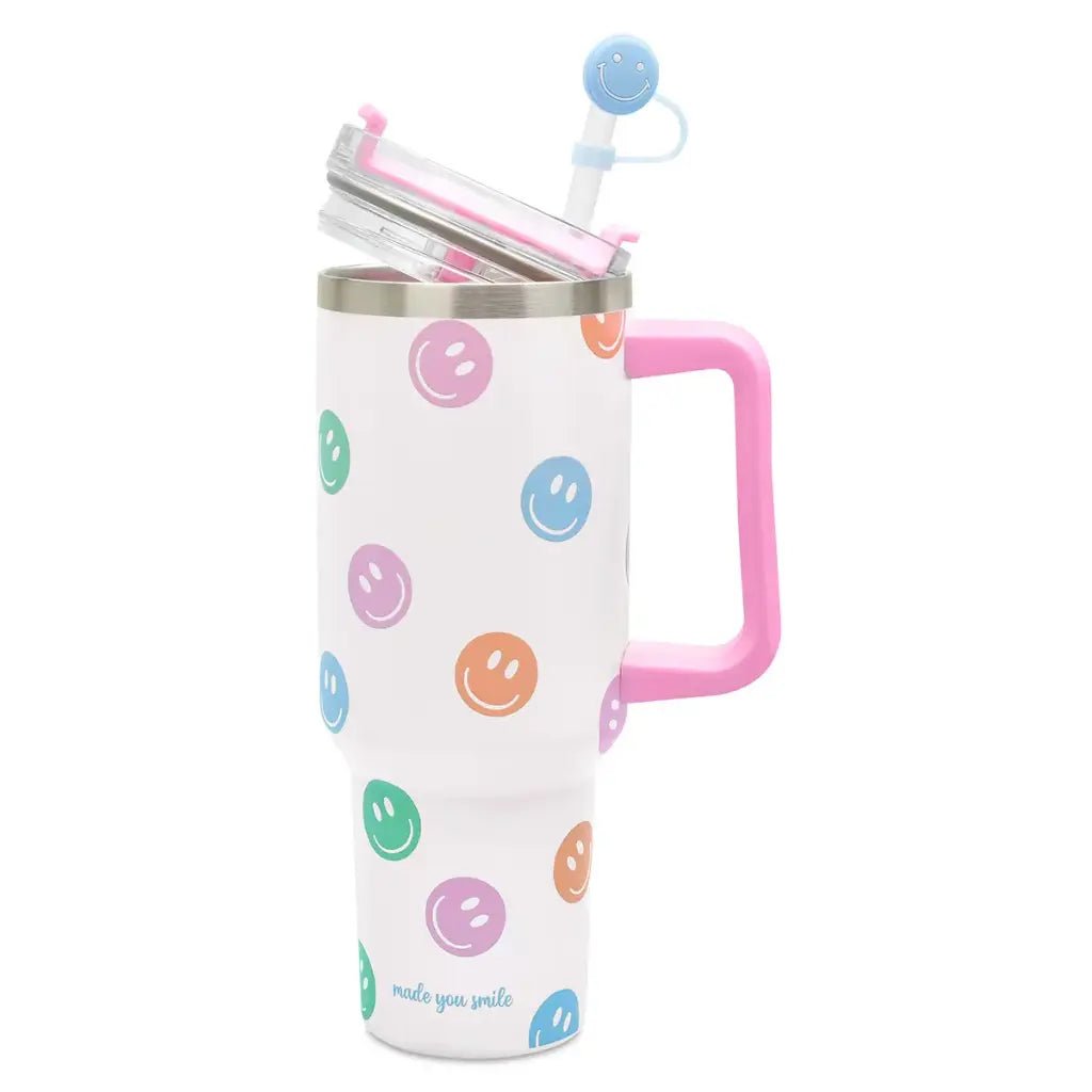 White insulated travel cup with colorful smiley faces, pink handle, and straw with topper