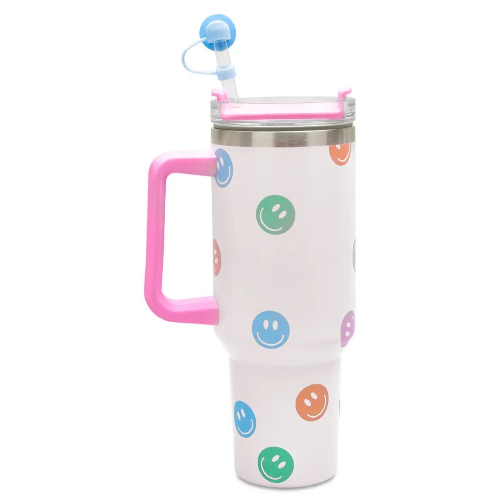 White insulated travel cup with colorful smiley faces, pink handle, and straw with topper