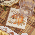 Fall-themed scalloped cocktail napkin with illustrated pumpkins and gingham bow