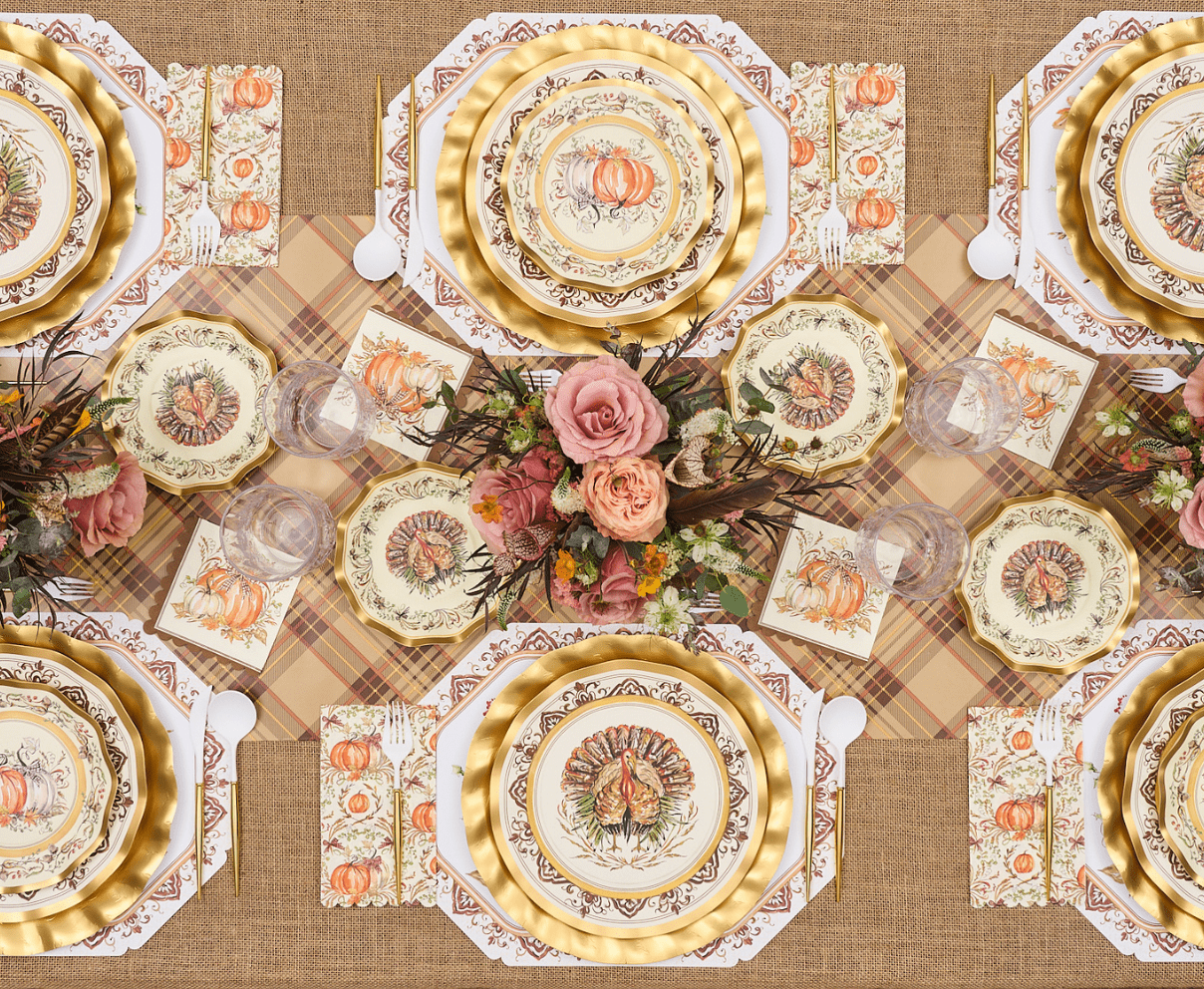 Decorative table setting with patterned plates, napkins, and a floral centerpiece on a checkered tablecloth.