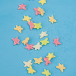 Colorful star-shaped candies on a blue background