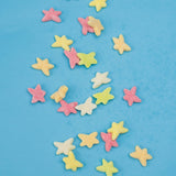 Colorful star-shaped candies on a blue background