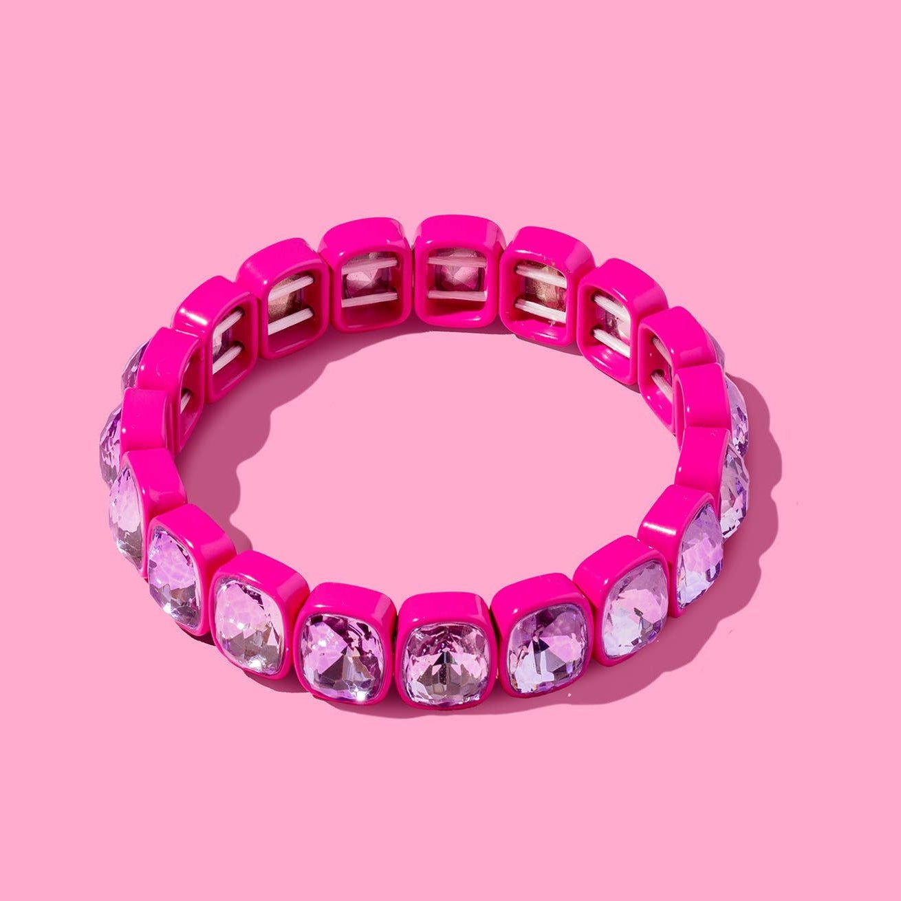 Pink bracelet with gemstones on a pink background