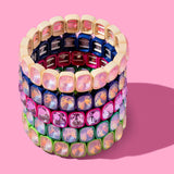 Colorful beaded bracelet on a pink background