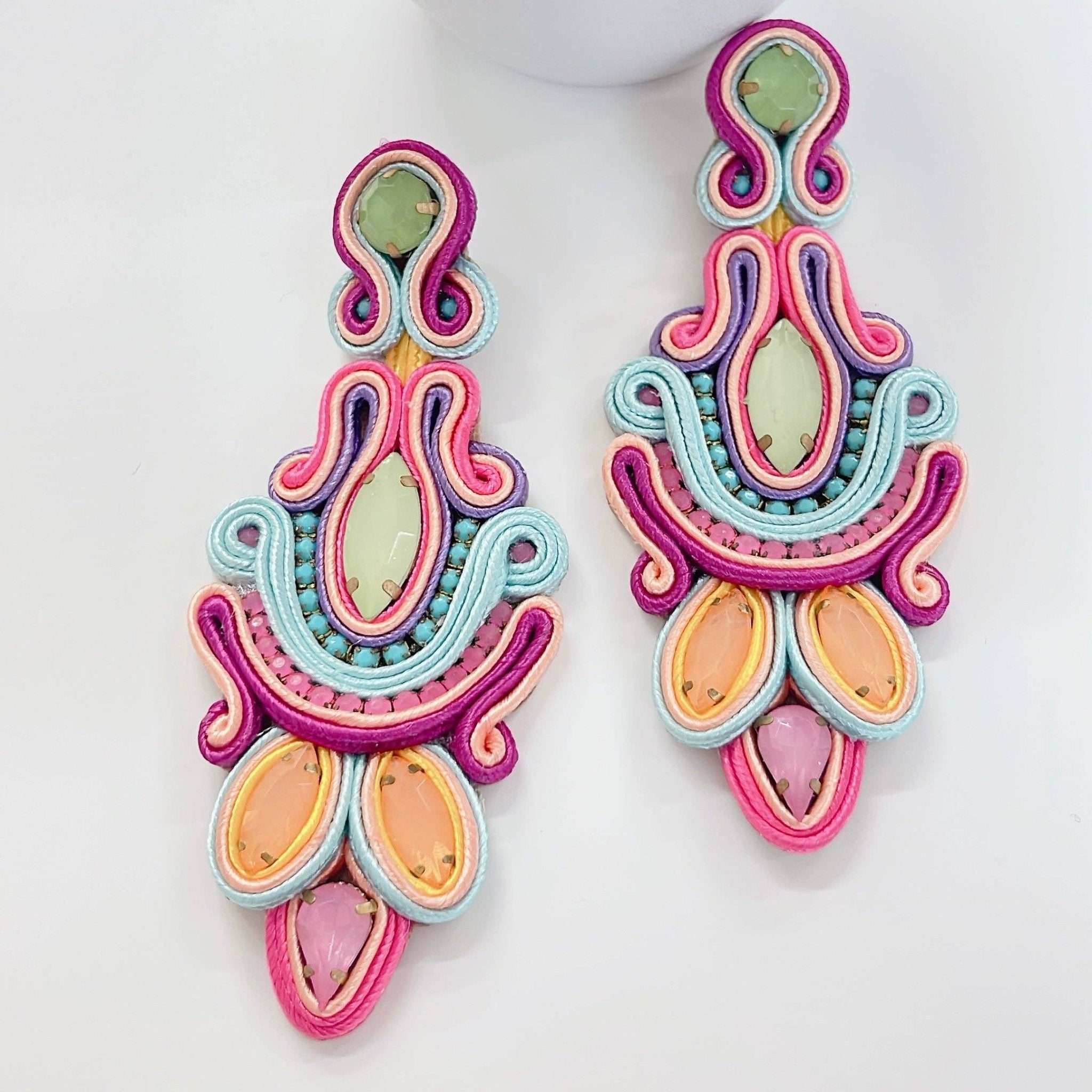 Colorful soutache earrings on a white background