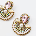 Jewelry earrings with pink, white, and gold elements on a white background