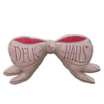 Pink velvet bow-shaped pillow with embroidered “Deck the Halls”
