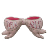 Pink velvet bow-shaped pillow with embroidered “Deck the Halls”