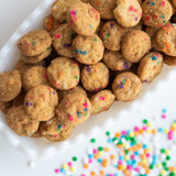 cookies with colorful sprinkles on a white surface