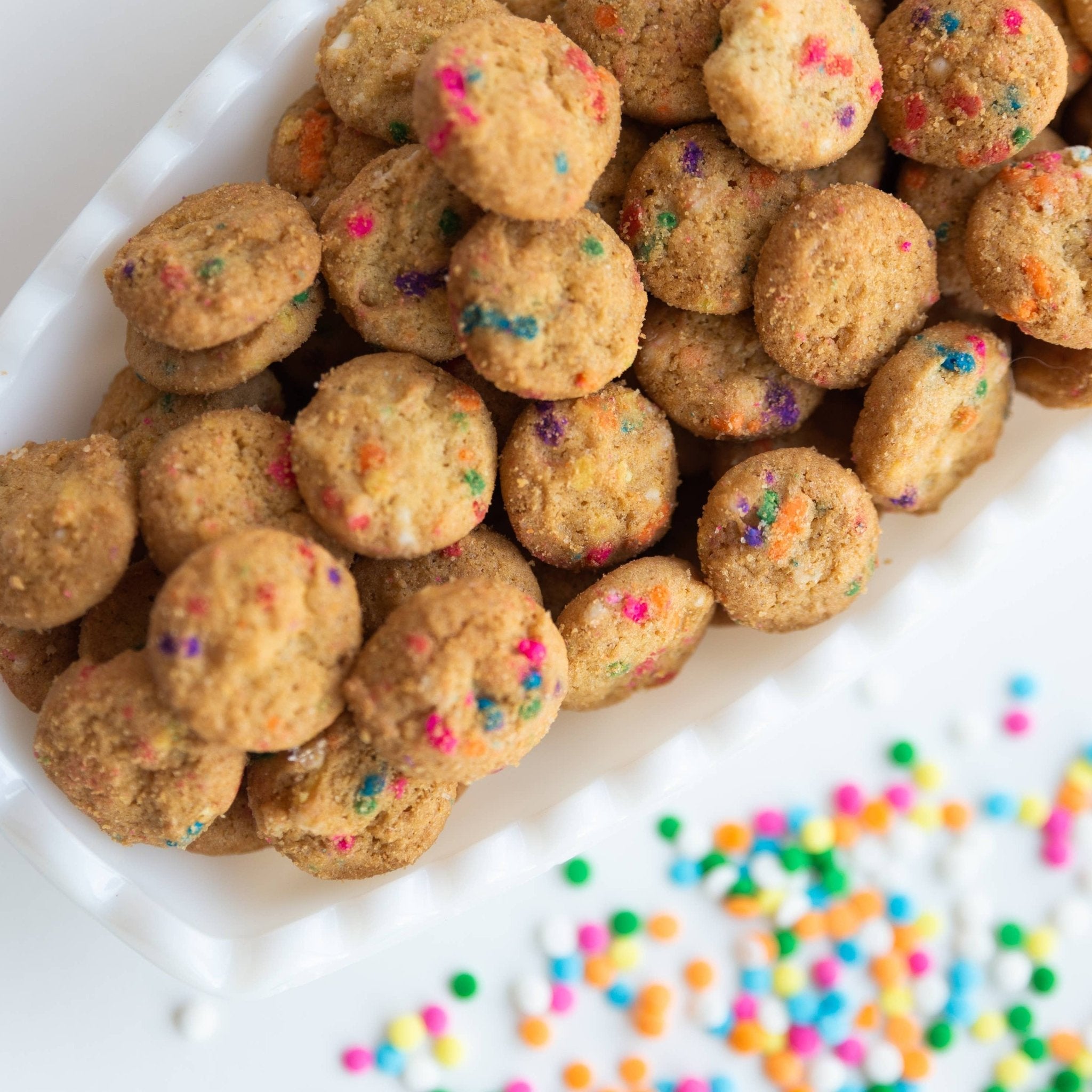 cookies with colorful sprinkles on a white surface